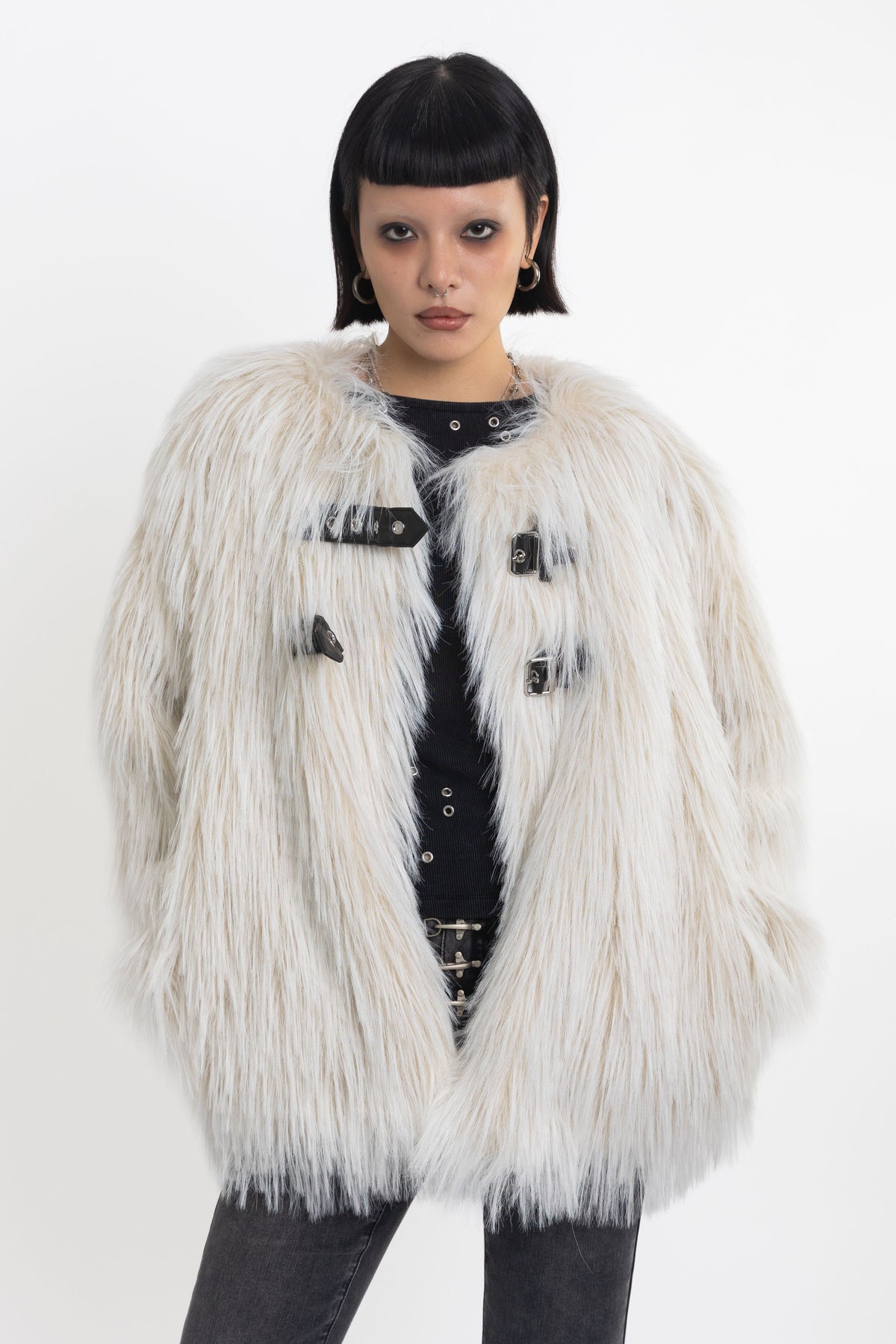 Ecru shaggy faux fur jacket with faux leather eyelet detail straps, worn by model