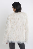 Ecru shaggy faux fur jacket with faux leather eyelet detail straps, worn by model