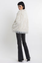 Ecru shaggy faux fur jacket with faux leather eyelet detail straps, worn by model