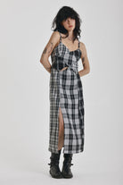Black and white mixed check midi dress with cut-out panels and thigh split, worn by model