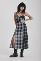 Black and white mixed check midi dress with cut-out panels and thigh split, worn by model