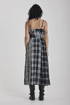 Black and white mixed check midi dress with cut-out panels and thigh split, worn by model