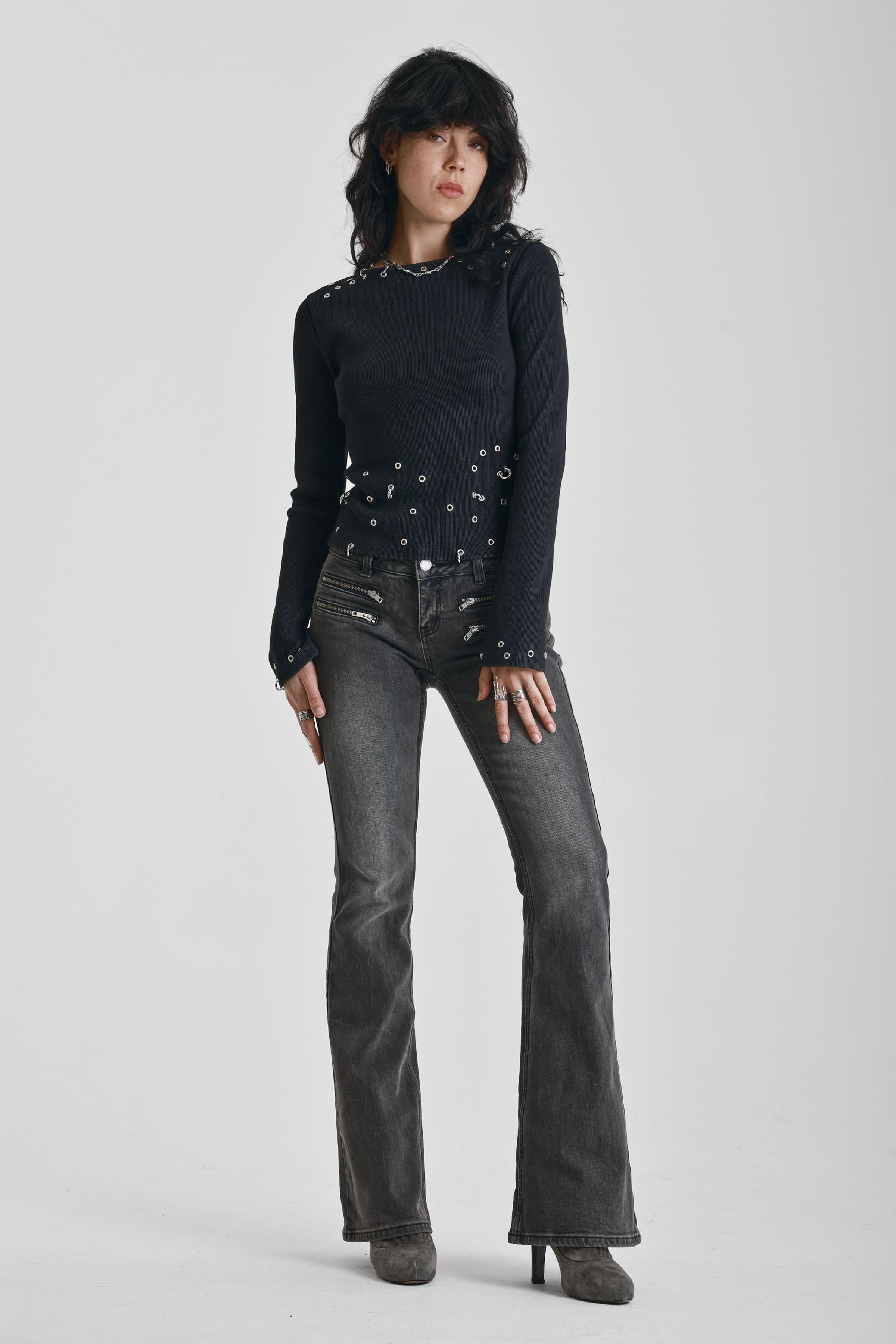 Washed black flare jeans with zip detail, worn by model