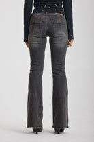 Washed black flare jeans with zip detail, worn by model