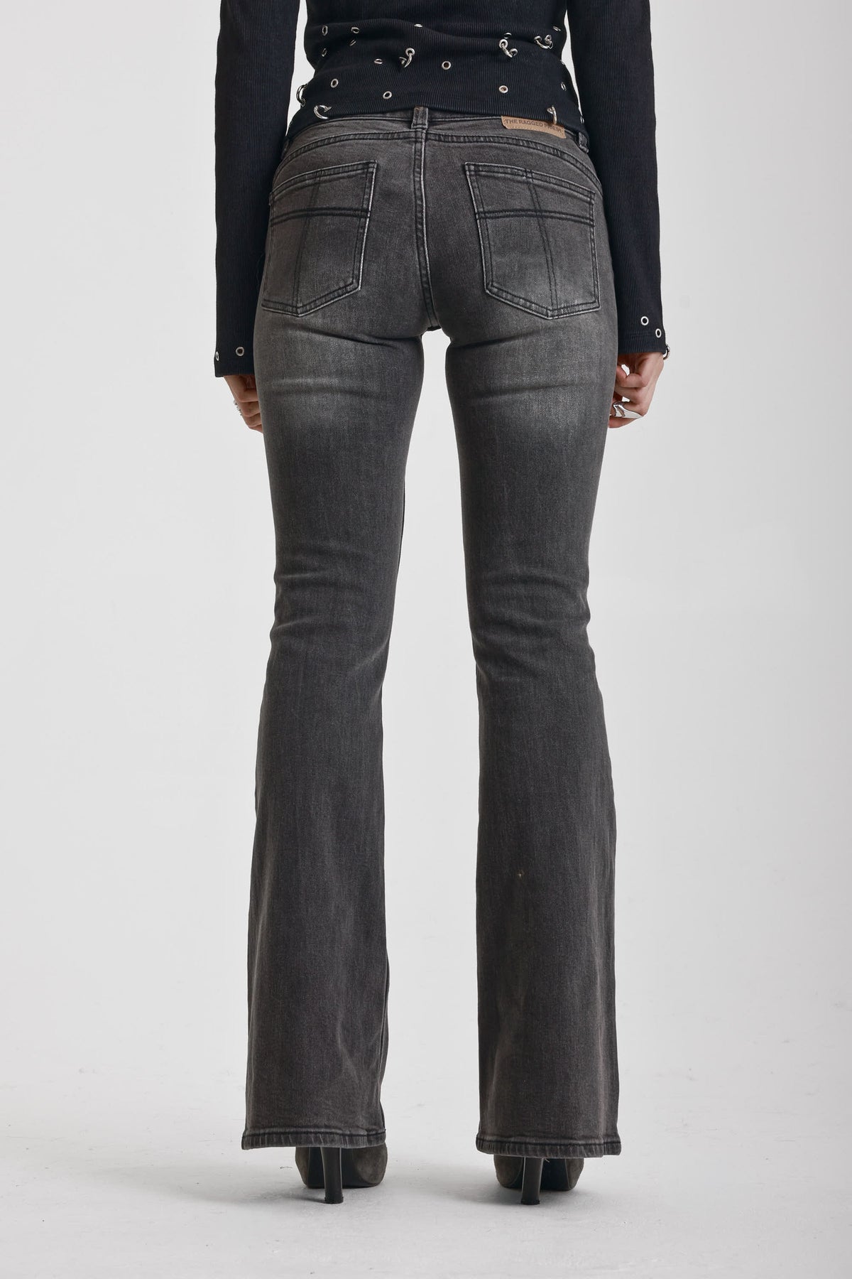 Washed black flare jeans with zip detail, worn by model
