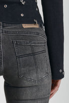 Washed black flare jeans with zip detail, worn by model
