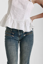 Dirty blue wash flare jeans with zip detail, worn by model