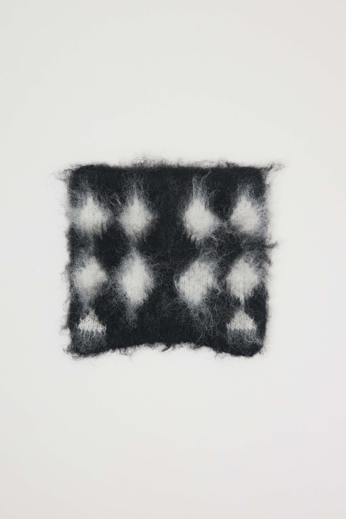 Black and white diamond argyle check knitted beanie with ears.