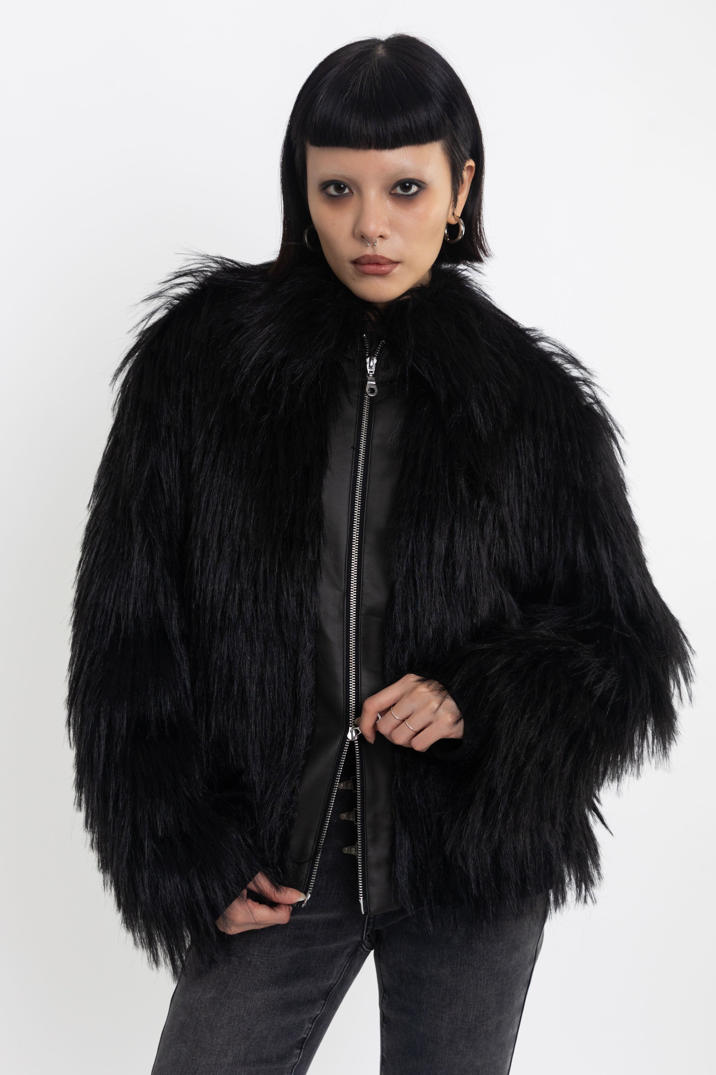 Black shaggy faux fur jacket with pu faux leather panel, worn by model