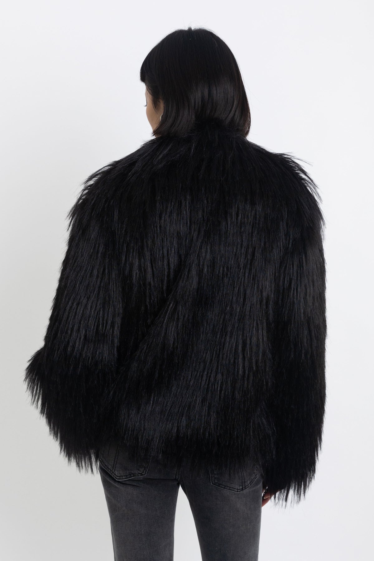 Black shaggy faux fur jacket with pu faux leather panel, worn by model