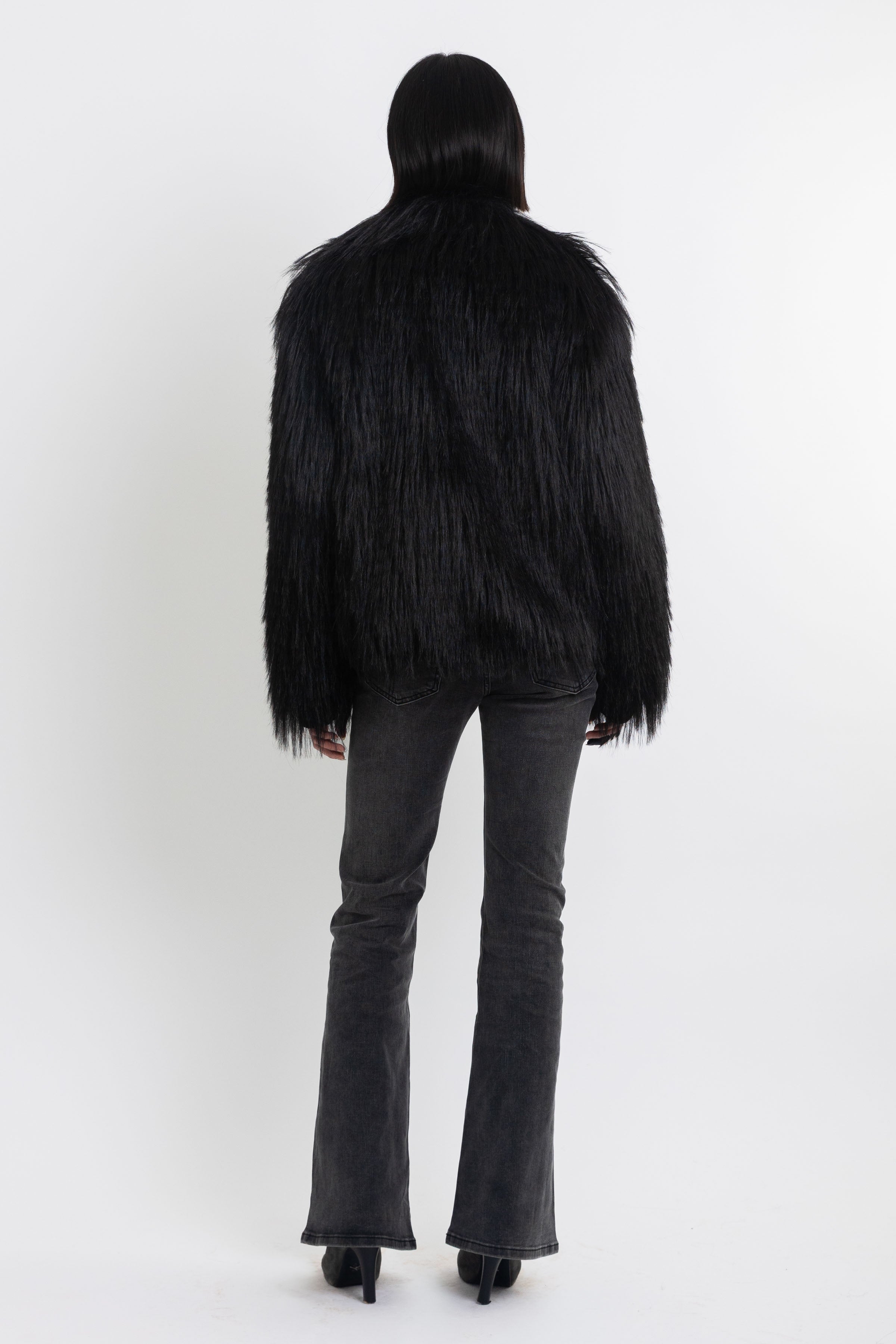 Black shaggy faux fur jacket with pu faux leather panel, worn by model