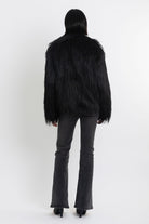 Black shaggy faux fur jacket with pu faux leather panel, worn by model