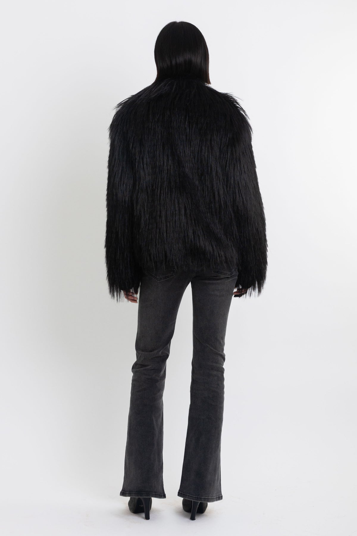 Black shaggy faux fur jacket with pu faux leather panel, worn by model