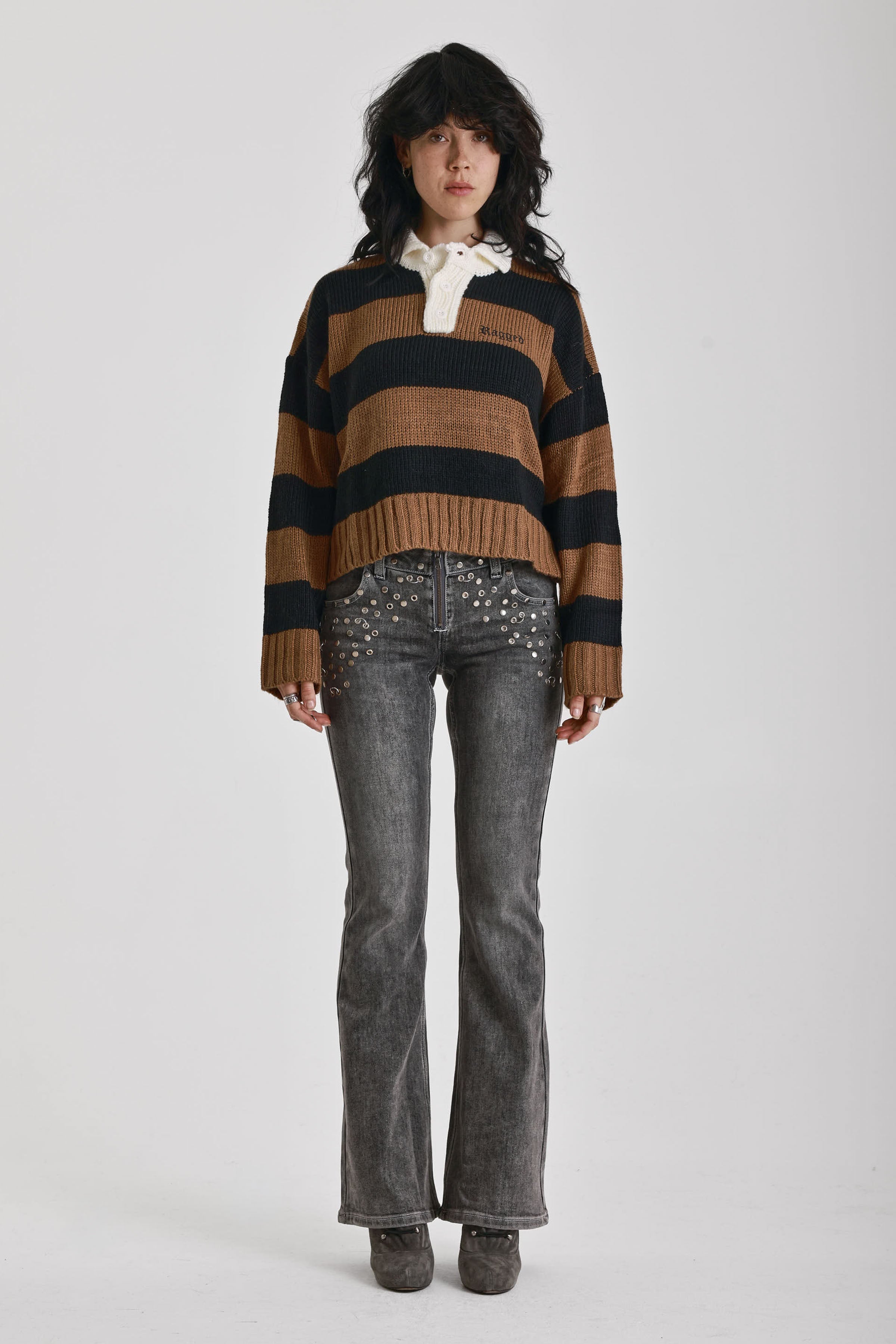 Black and brown stripe rugby polo knit jumper with varsity back print, worn by model