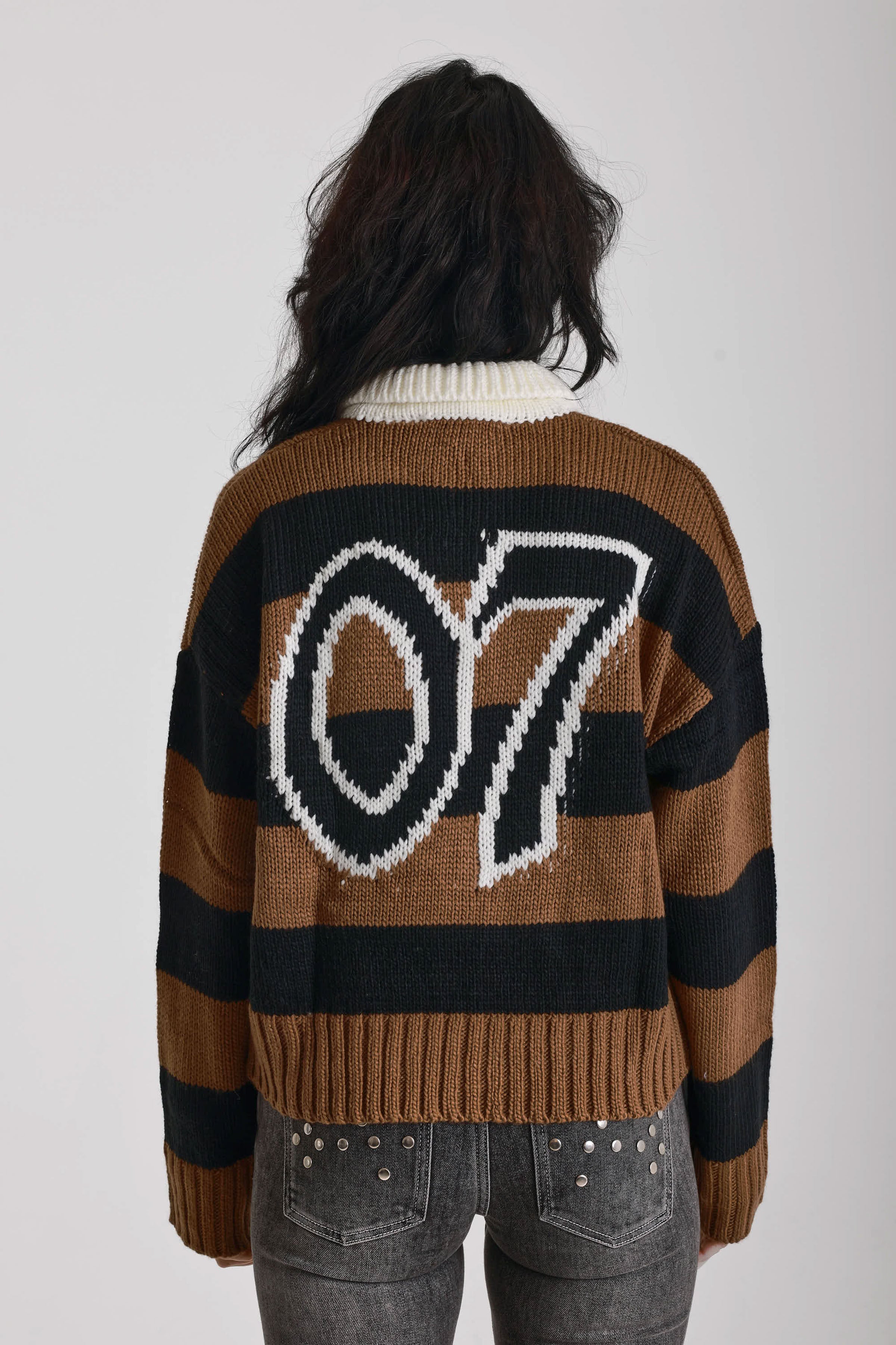 Black and brown stripe rugby polo knit jumper with varsity back print, worn by model