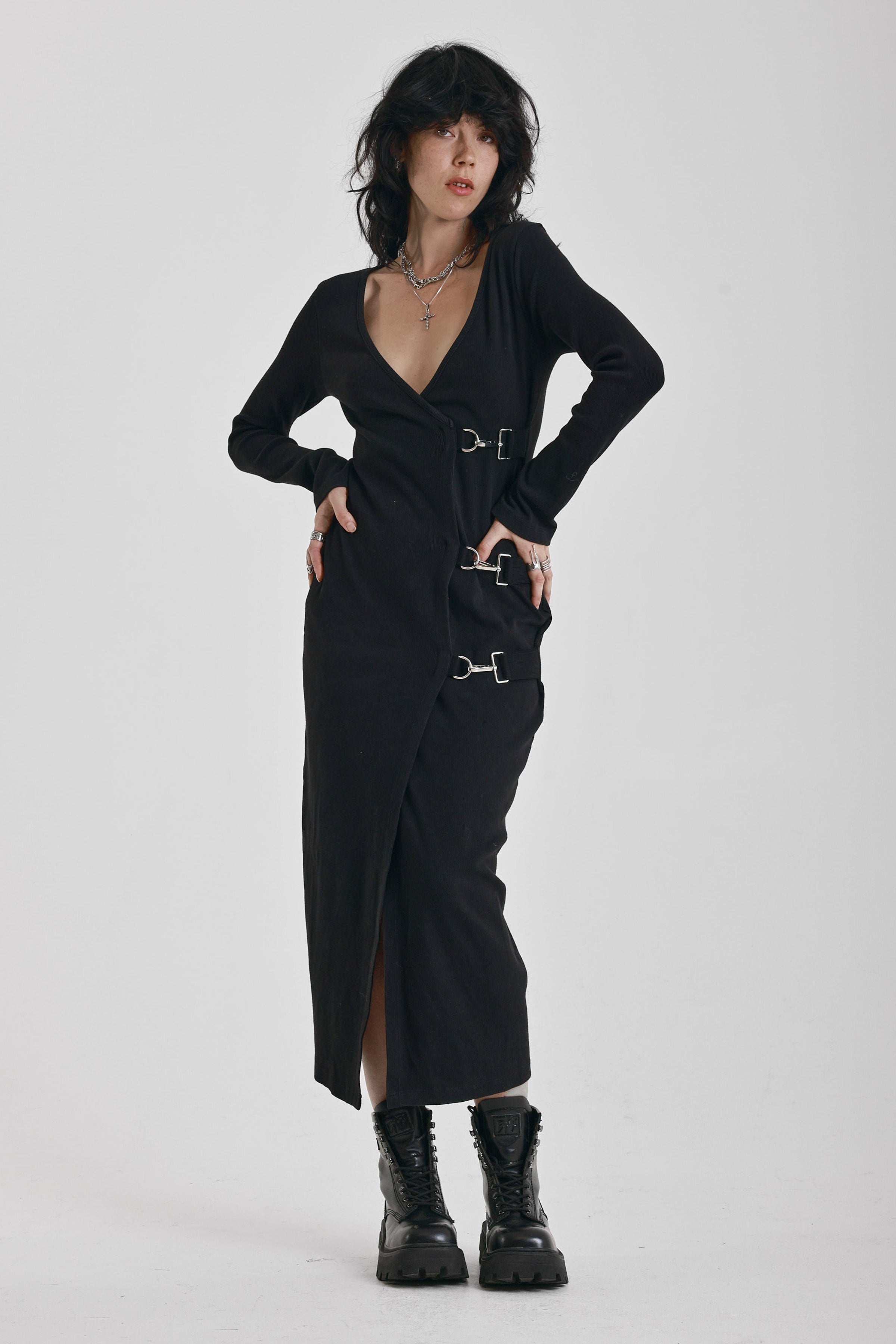 Black wrap front midi dress with silver trigger clasps and long sleeves, worn by model