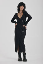 Black wrap front midi dress with silver trigger clasps and long sleeves, worn by model