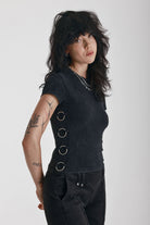 Acid wash black baby t-shirt with short sleeves and silver O-ring hardware, worn by model
