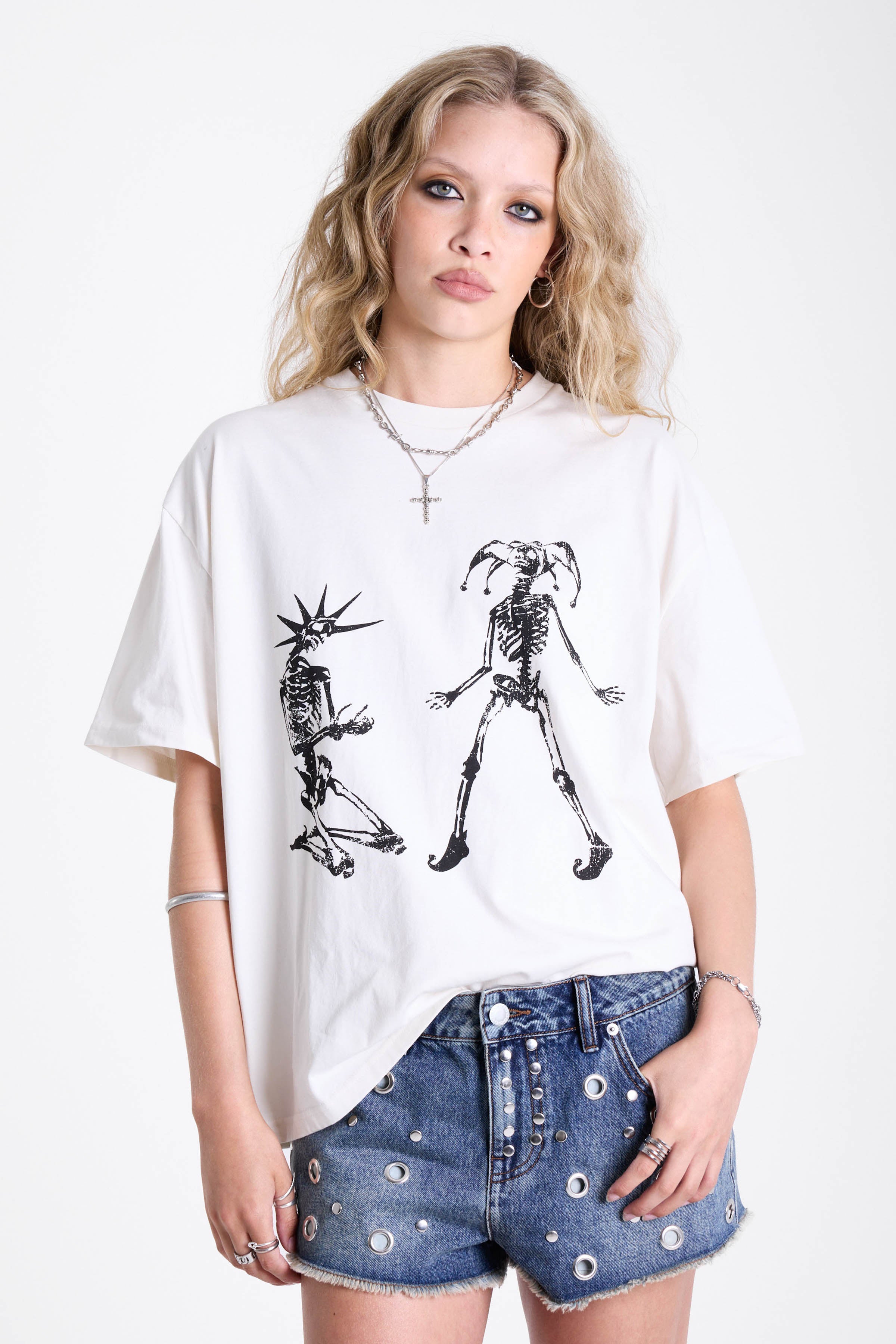 White oversized t-shirt with skeleton jester graphic print, worn by model
