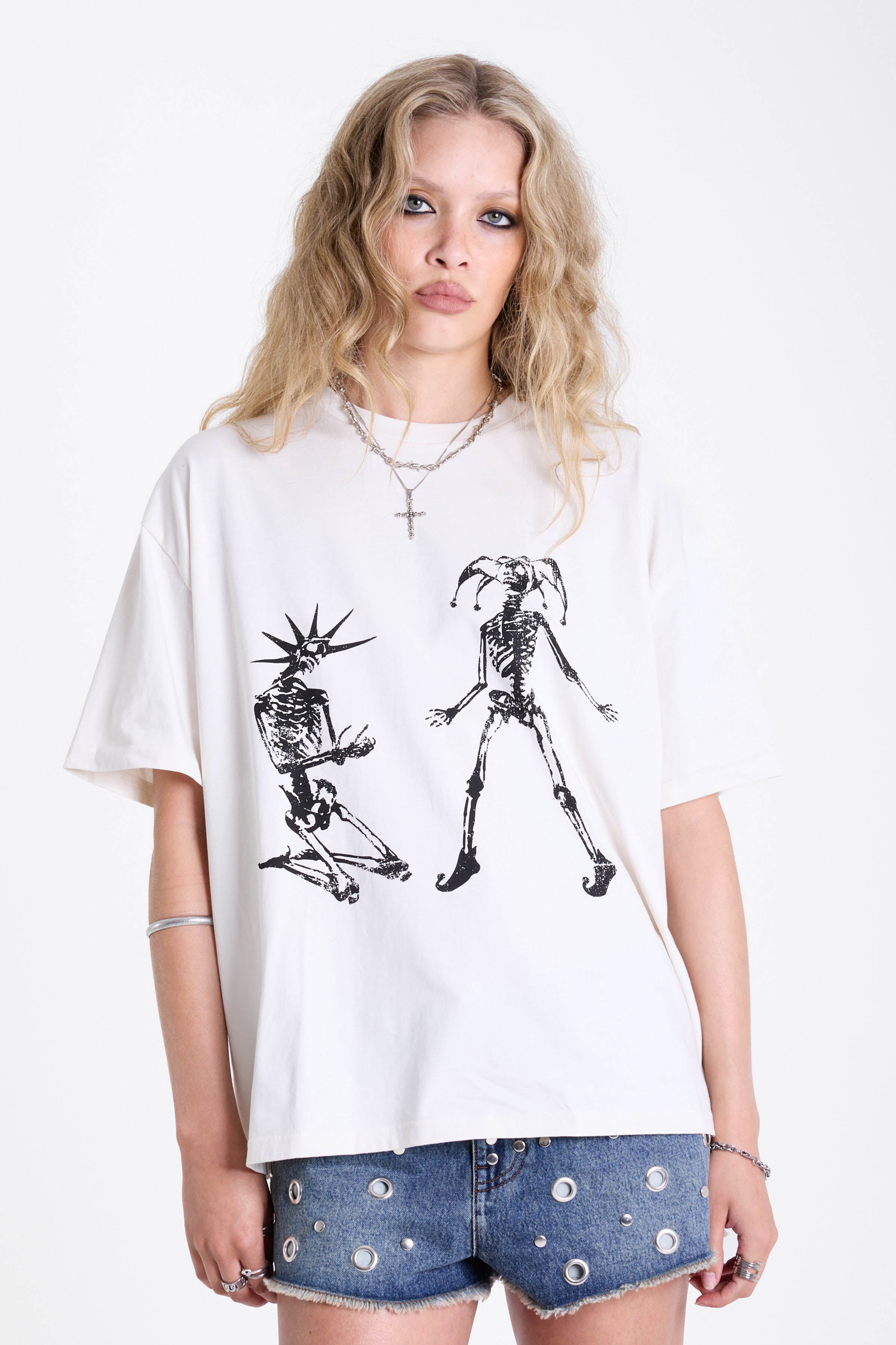 White oversized t-shirt with skeleton jester graphic print, worn by model