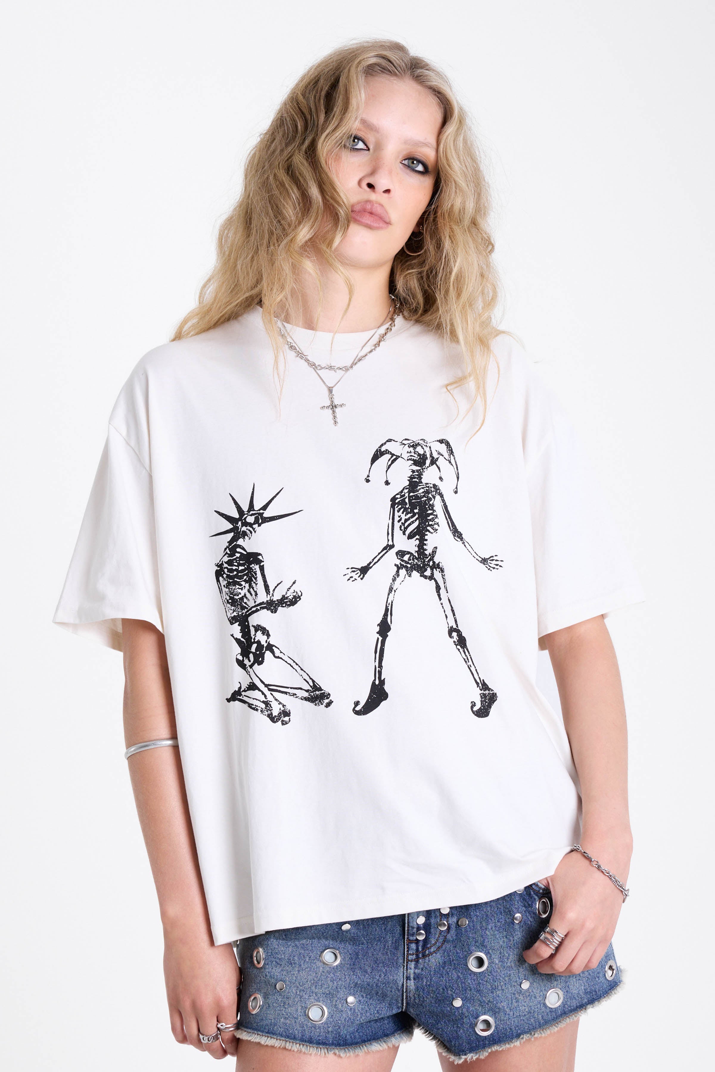 White oversized t-shirt with skeleton jester graphic print, worn by model