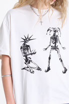 White oversized t-shirt with skeleton jester graphic print, worn by model