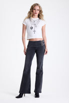Washed black flare bootcut jeans with double buckle belt detail, worn by model