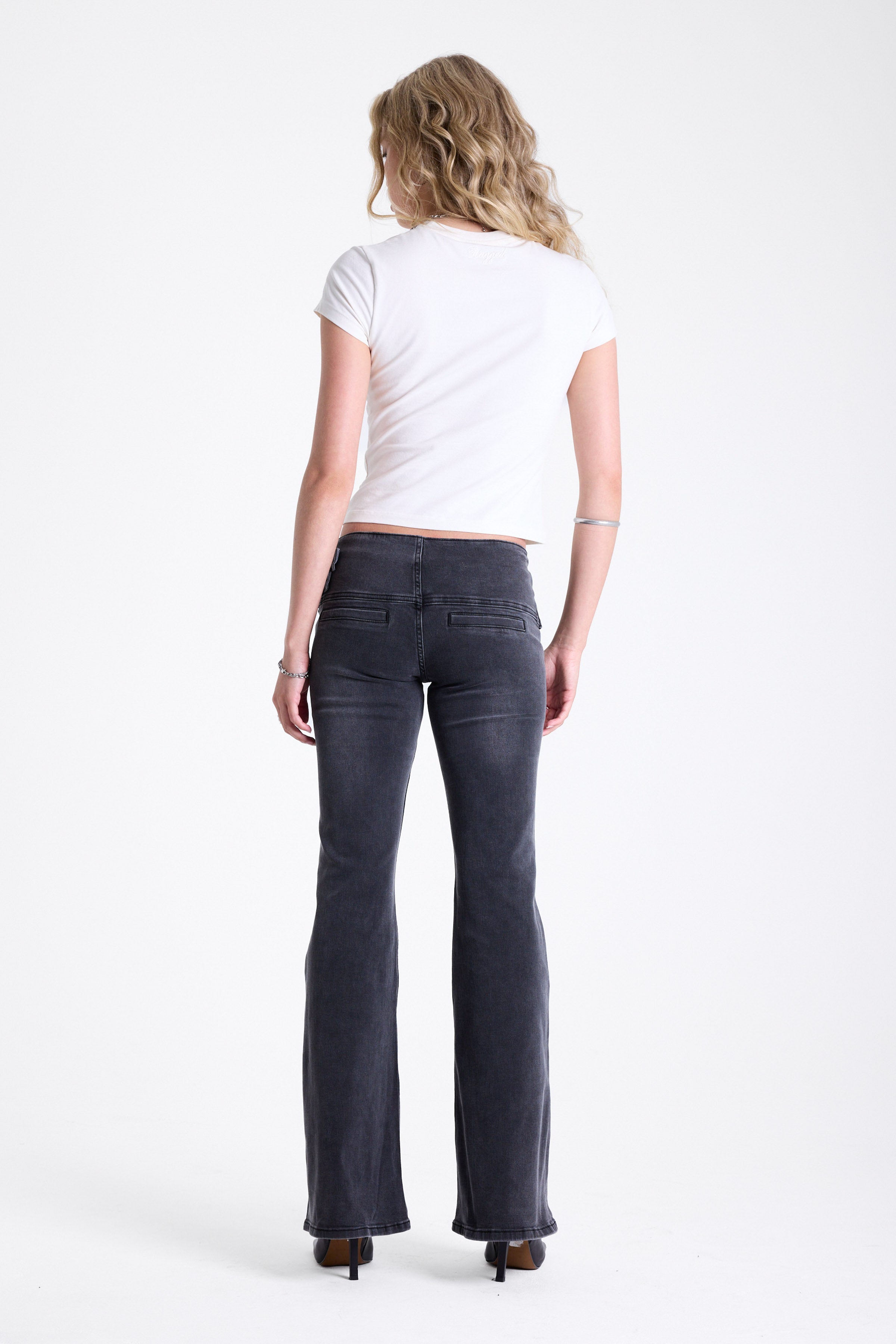 Washed black flare bootcut jeans with double buckle belt detail, worn by model