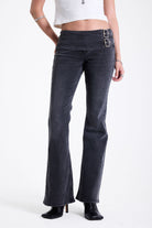 Washed black flare bootcut jeans with double buckle belt detail, worn by model