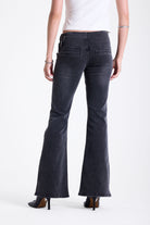 Washed black flare bootcut jeans with double buckle belt detail, worn by model