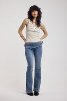 Blue flare bootcut jeans with double buckle belt detail, worn by model