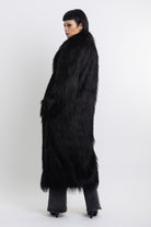 Longline black shaggy faux fur coat with silver horsebit clasps and shawl collar, worn by model