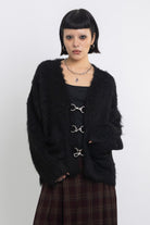 Black fluffy longline v-neck cardigan with oversized silver horsebit hardware clasps, worn by model