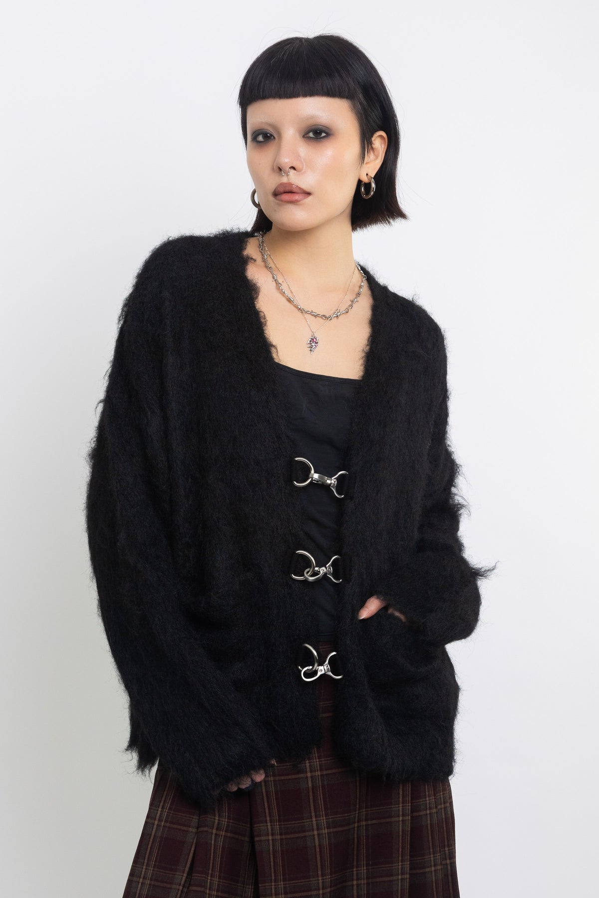 Black fluffy longline v-neck cardigan with oversized silver horsebit hardware clasps, worn by model