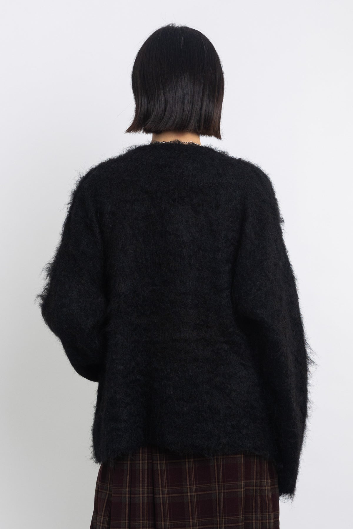 Black fluffy longline v-neck cardigan with oversized silver horsebit hardware clasps, worn by model
