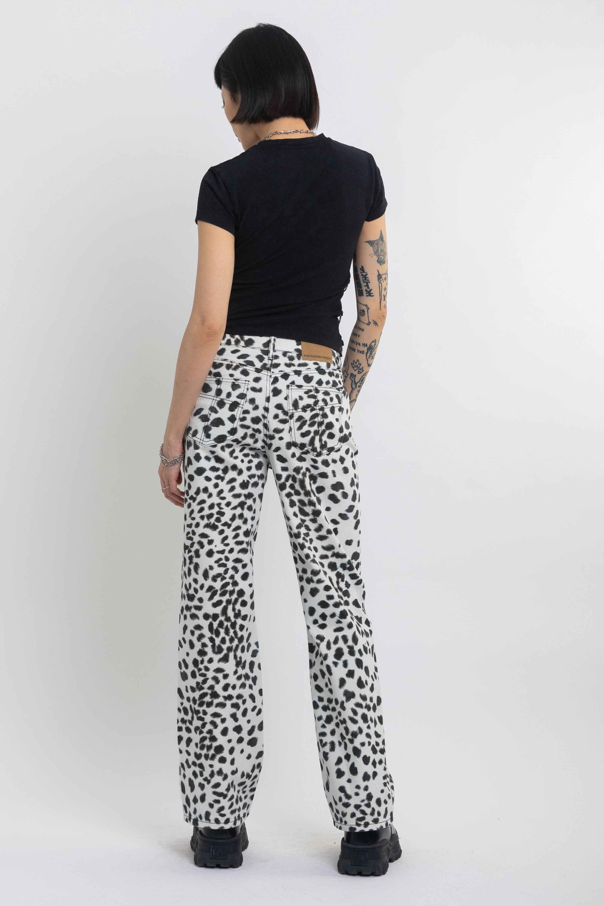 Black and white dalamatian spot print relaxed leg jeans, worn by model