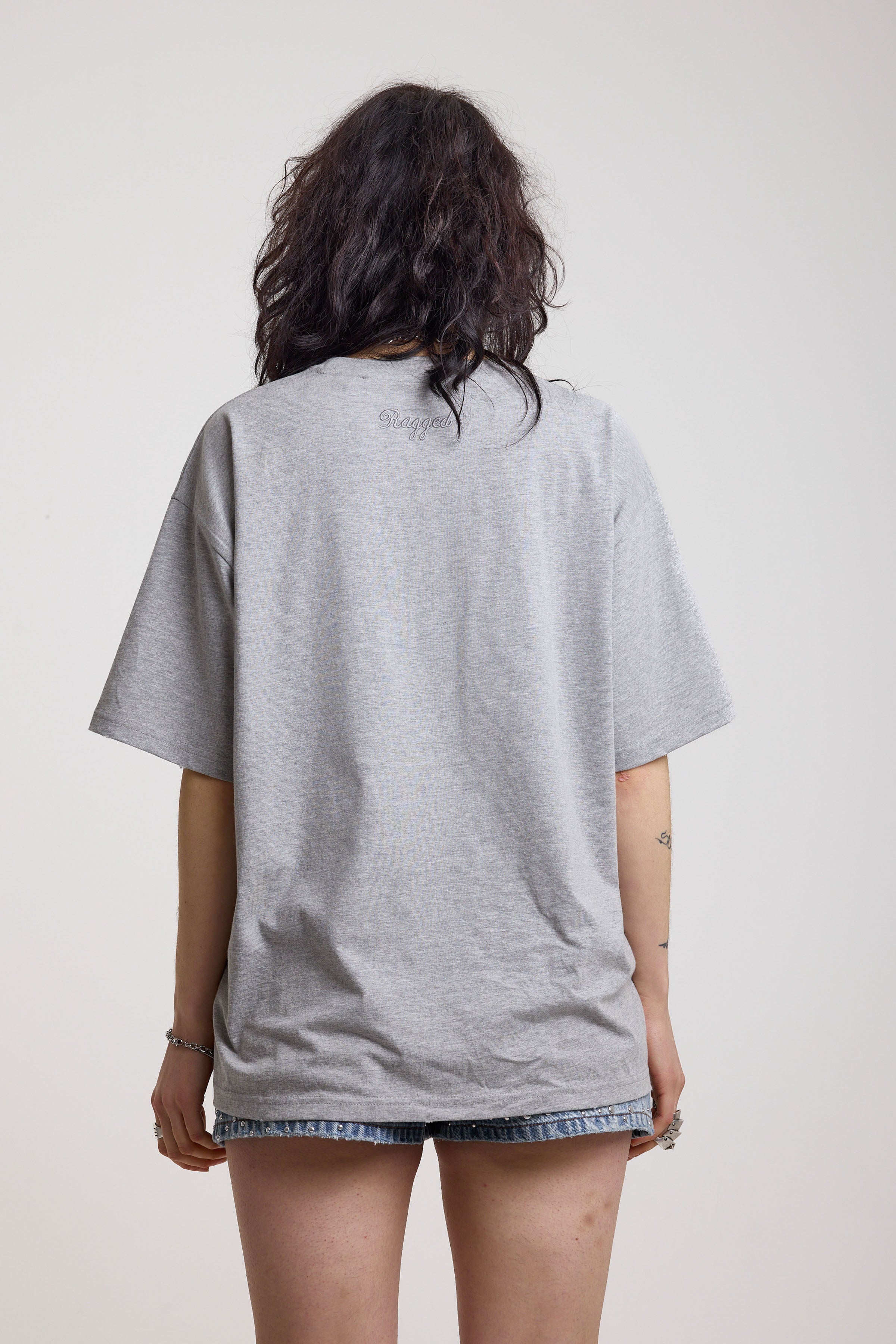 Grey marl oversized baby t-shirt with rosary pendants and cross necklace graphic, worn by a model