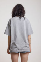Grey marl oversized baby t-shirt with rosary pendants and cross necklace graphic, worn by a model