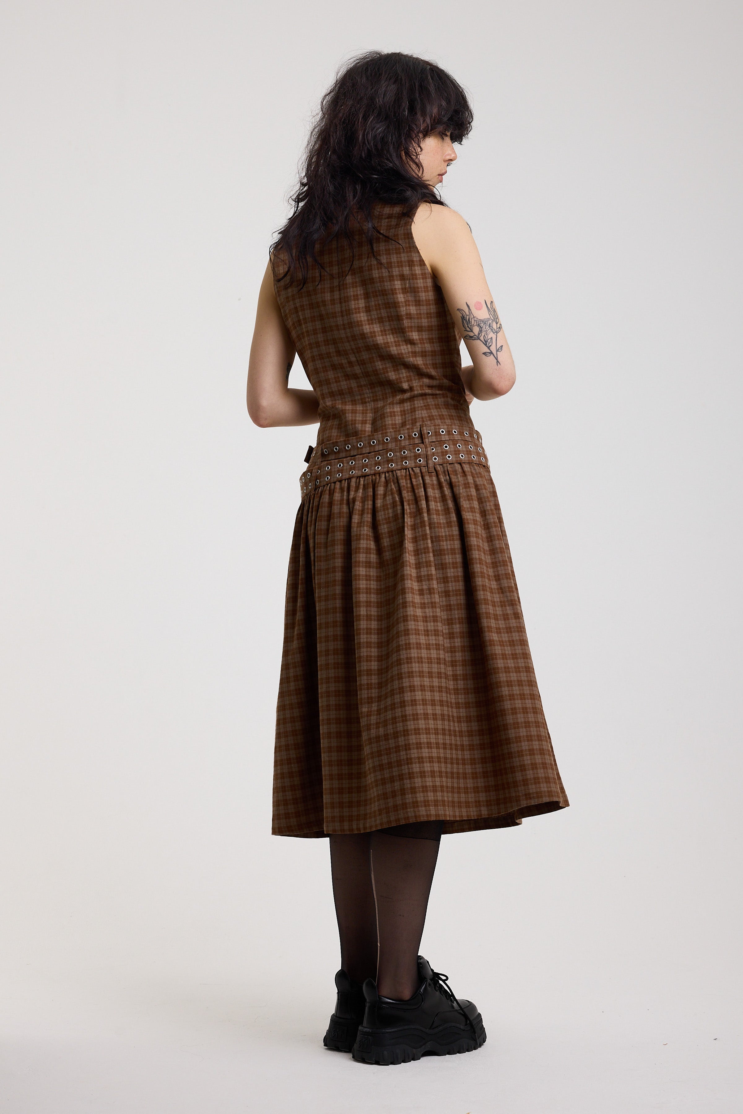 Back of brown tartan check midi dress with double eyelet belt and full skirt, worn by model
