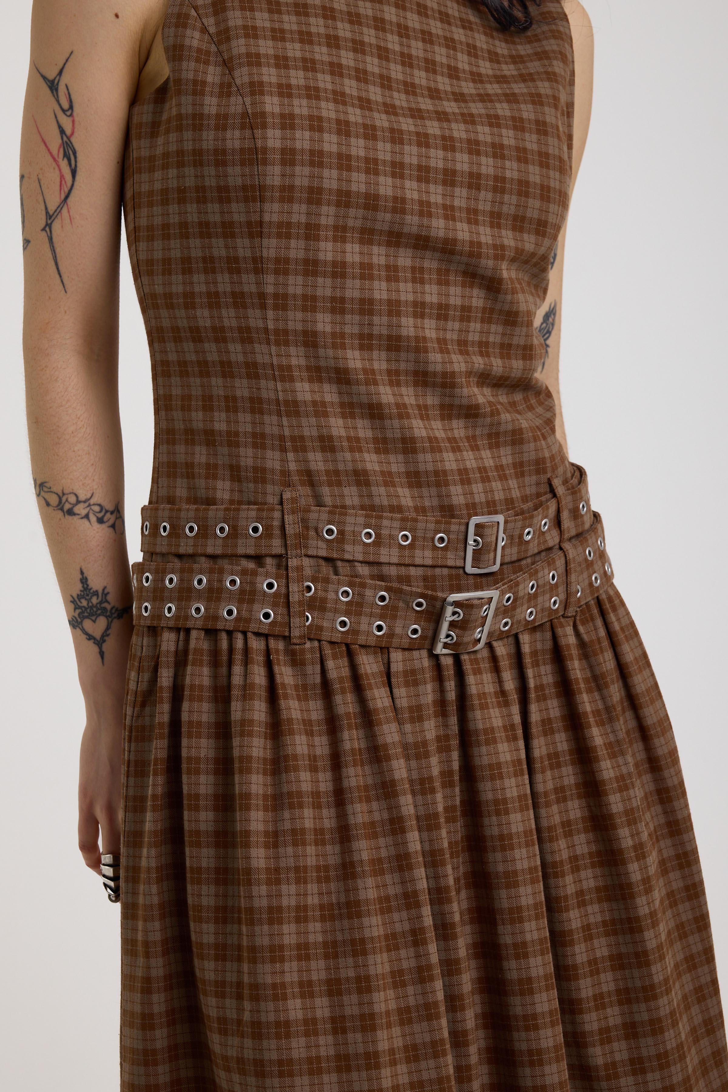 Close up of double eyelet detail belt on brown tartan check midi dress, worn by model