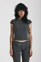 Grey and black stripe cap sleeve t-shirt with open back and eyelet buckle straps, worn by model
