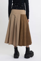Spliced check pleated kilt midi skirt with silver clasp detail and thigh high split, worn by model
