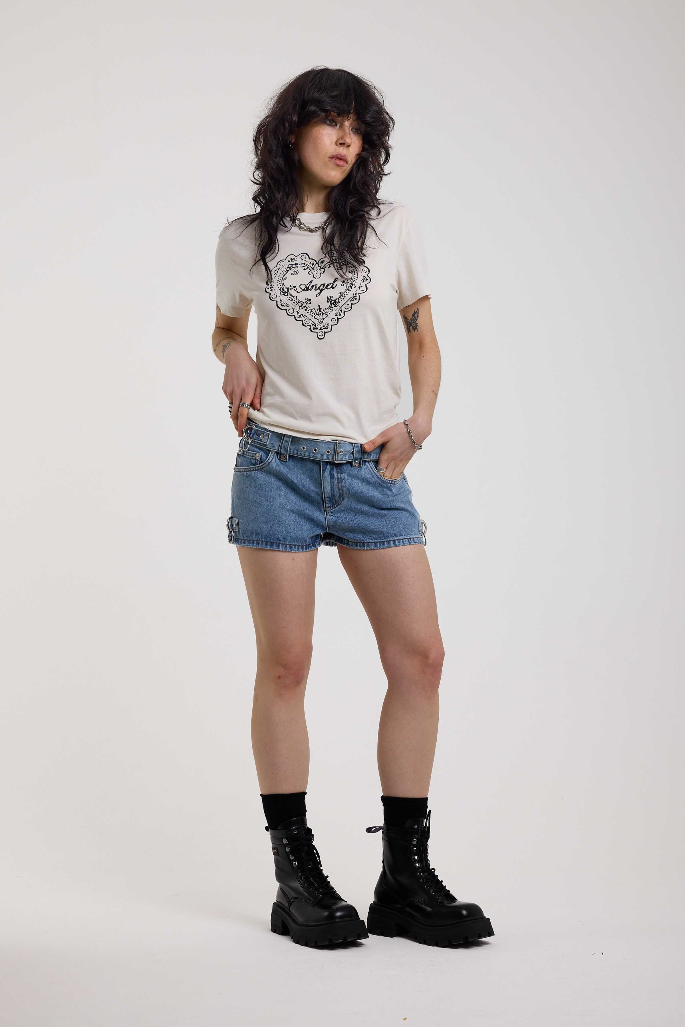 Light blue denim hotpants with silver D ring hardware and studded eyelet belt, worn by model