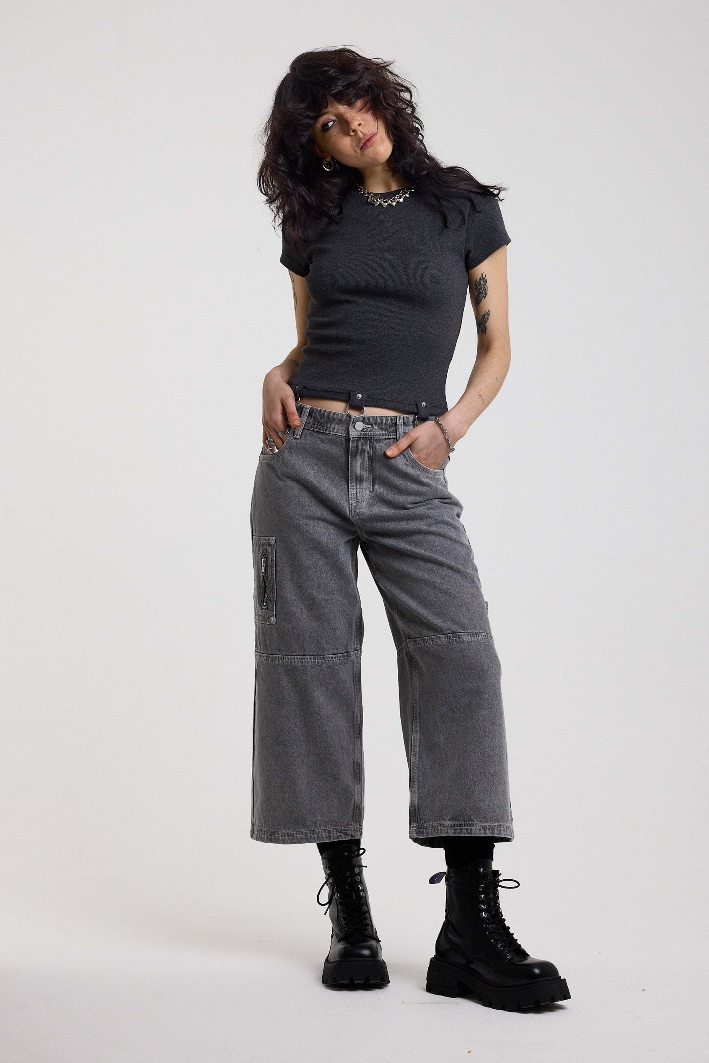 Washed grey baggy cropped carpenter jeans with hardware detail, worn by model