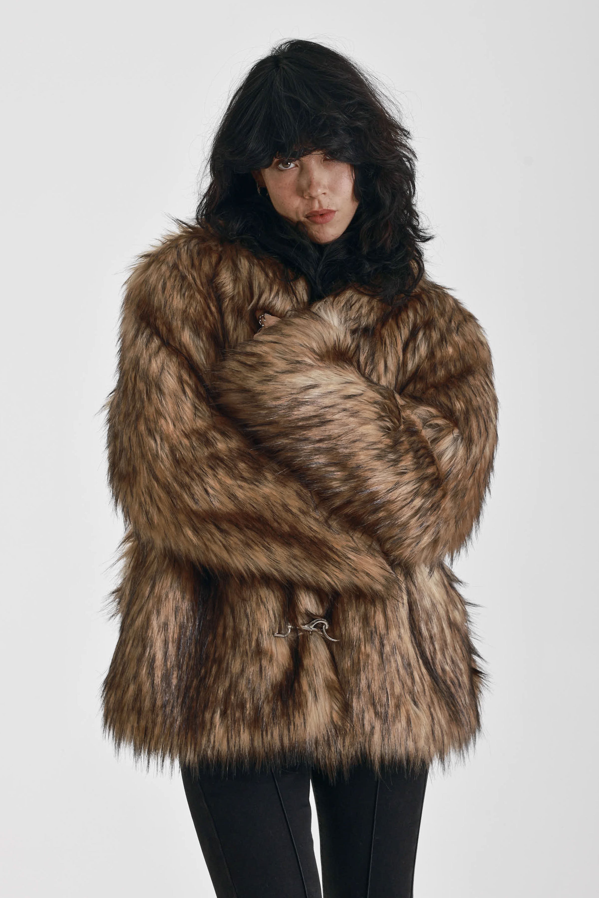 Oversized brown faux fur jacket with oversized collar and silver buckle clasps, worn by model