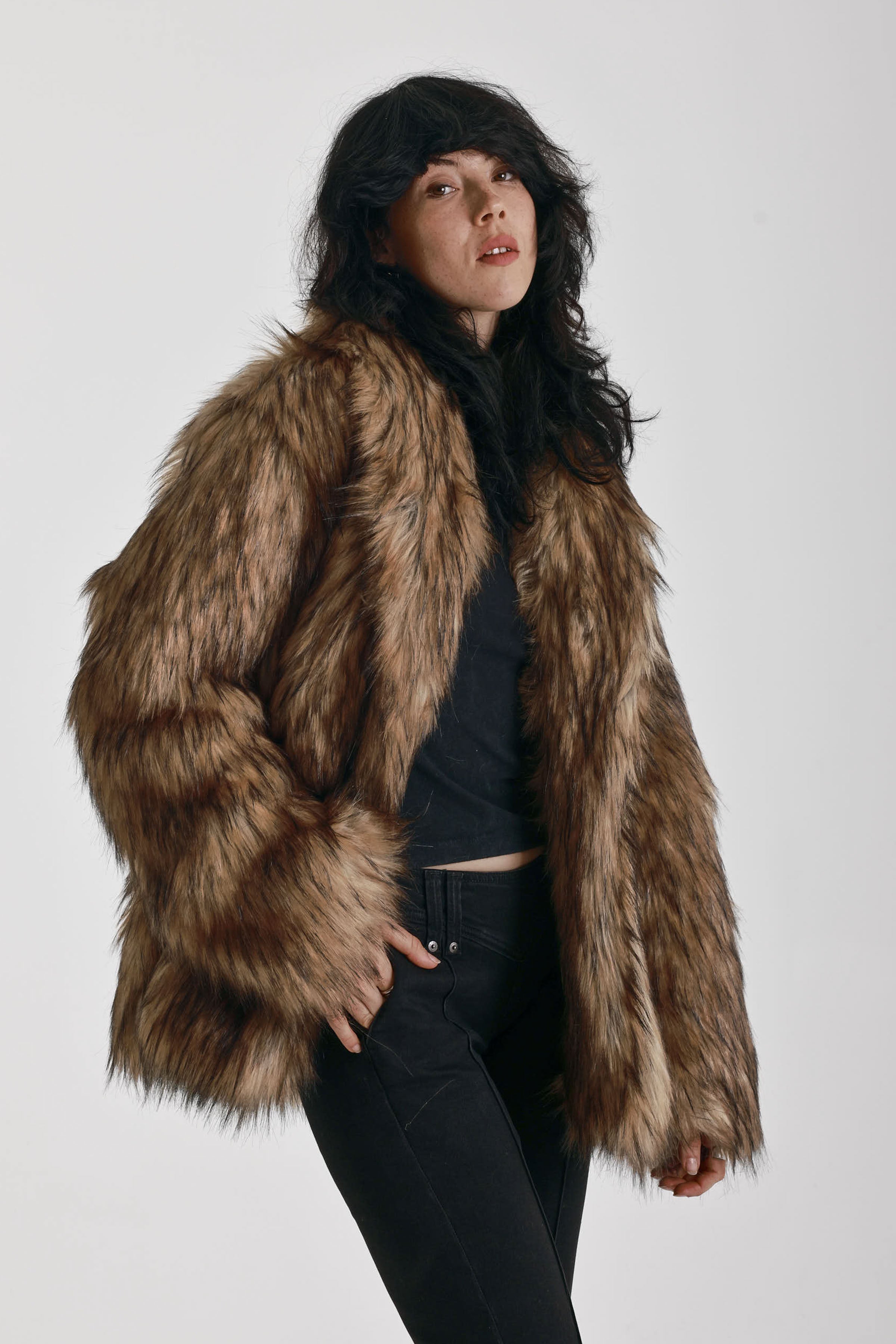 Oversized brown faux fur jacket with oversized collar and silver buckle clasps, worn by model
