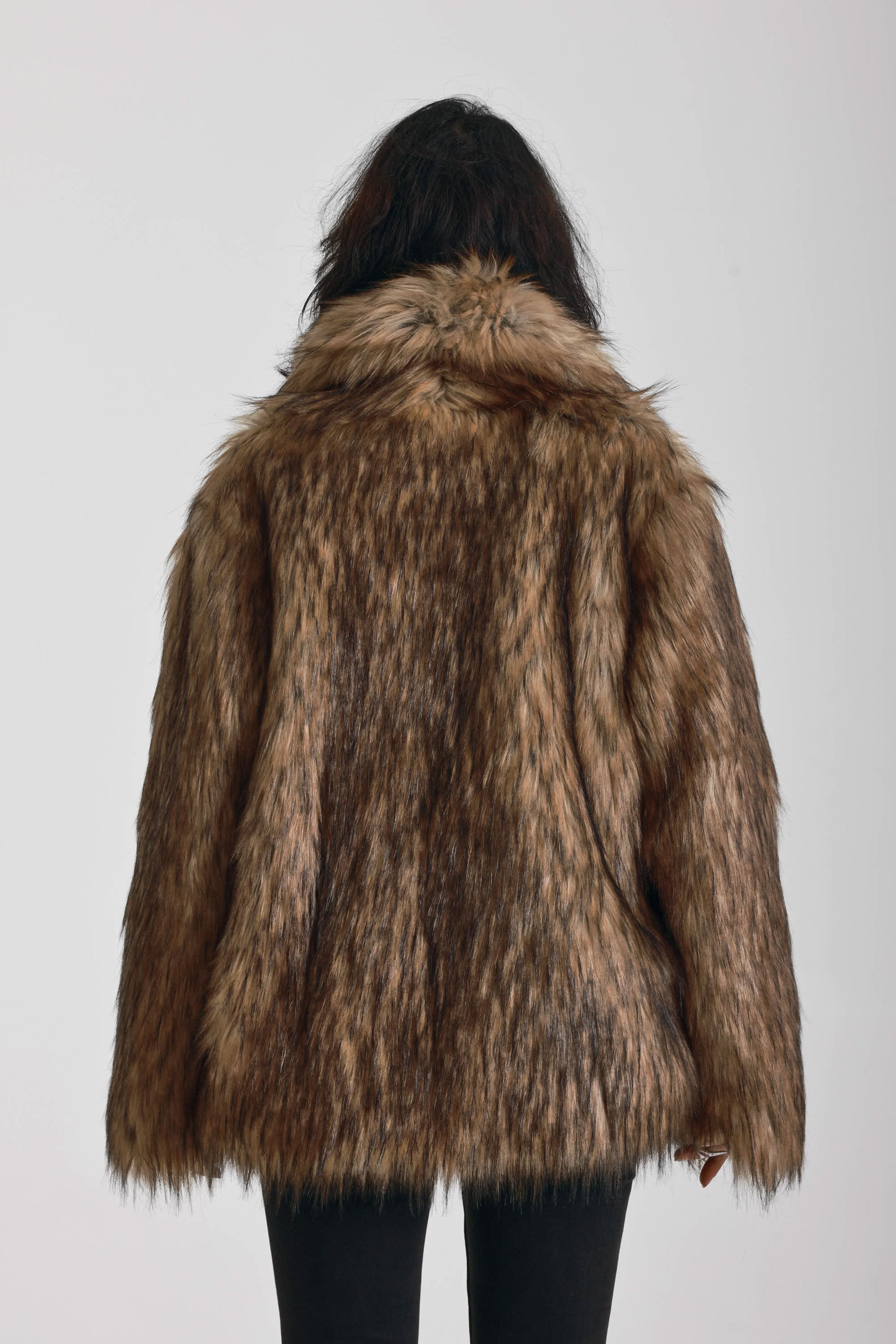 Oversized brown faux fur jacket with oversized collar and silver buckle clasps, worn by model