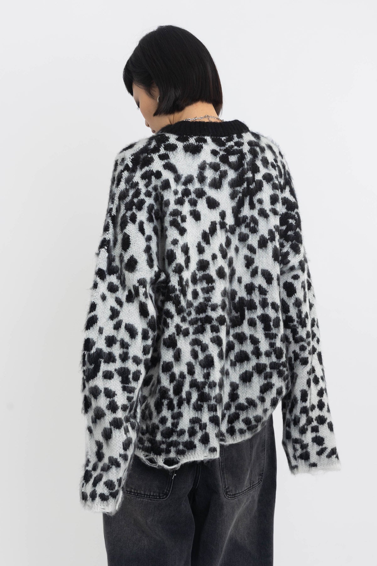 Black and white dalmatian print oversized fuzzy knit jumper, worn by model