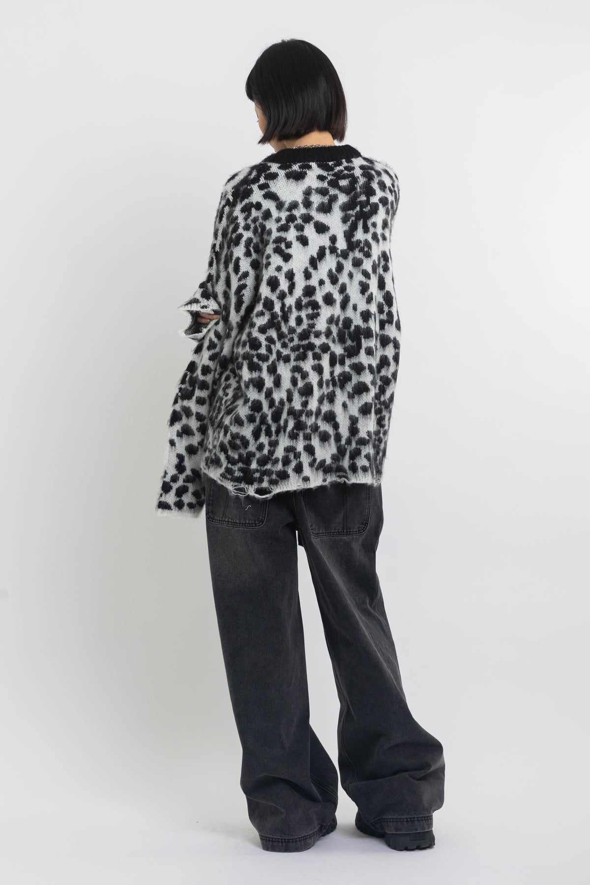Black and white dalmatian print oversized fuzzy knit jumper, worn by model