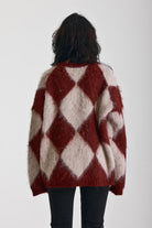 Burgundy and ecru argyle diamond check oversized knit jumper in brushed fluffy yarn, worn by model